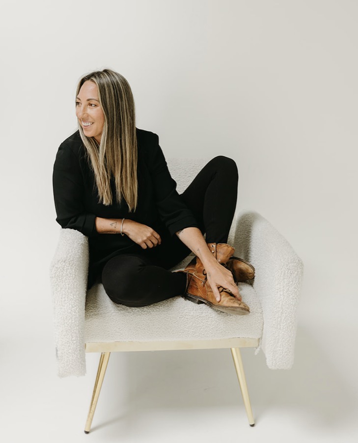Crystal Ortiz smiling in a studio armchair